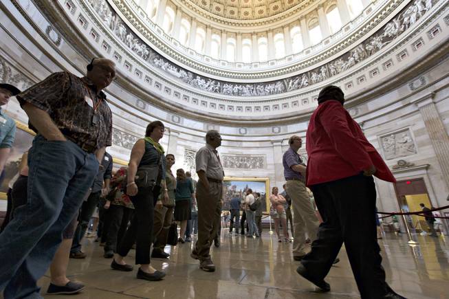 With hours to go until a possible government shutdown, visitors tour the Rotunda of the Capitol in Washington, D.C., on Monday, Sept. 30, 2013. Capitol officials said today that if a shutdown goes into effect, all organized tours of the Capitol and the Capitol Visitors Center will be suspended.