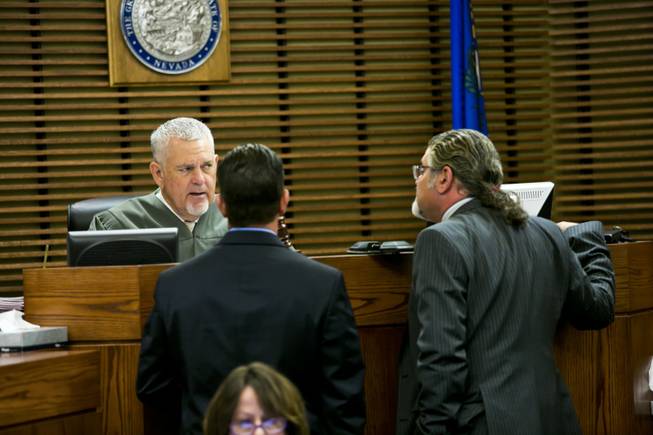 Judge David Gibson speaks with attorneys from both the prosecution and defence regarding Adrian Navarro-Canales, the 16-year-old accused of killing his mom and brother, Monday Sept. 30, 2013. Navarro-Canales appeared before Judge Gibson at the Henderson Justice Court for his 72 hour hearing,