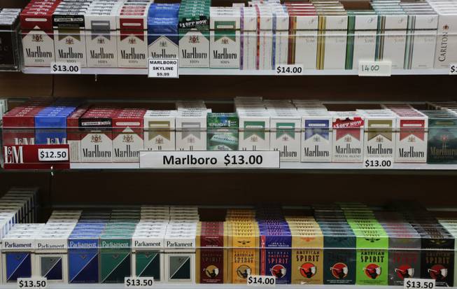 Cigarette packs are displayed at a smoke shop in New York, Monday, March 18, 2013. A new anti-smoking proposal would make New York the first city in the nation to keep tobacco products out of sight in retail stores. Mayor Michael Bloomberg says the goal is to reduce the youth smoking rate.