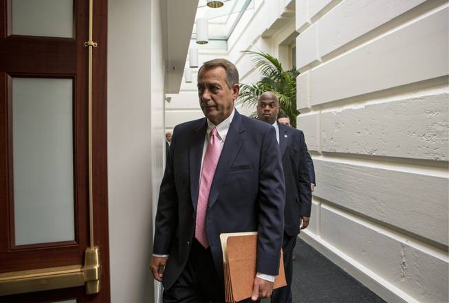 House Speaker John Boehner of Ohio, walks to join GOP House members for a caucus meeting on Capitol Hill in Washington, Tuesday, Sept. 10, 2013. Some conservative Republicans want to shut down the government if that's what it takes to block the "Obamacare" health program. The fiscal year ends Sept. 30, and government agencies will start shutting down if some type of budget bill isn't enacted by then and Boehner says he wants no government shutdown or default on the debt.