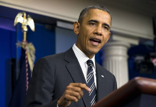 This Sept. 27, 2013 file photo, President Barack Obama gestures while making a statement regarding the budget fight in Congress and foreign policy challenges in the James Brady Press Briefing Room of the White House in Washington. Unless Congress acts before Tuesday to fund federal spending, some of the government would shut down. Separately, the government will run out of money to pay its bills by late October unless Congress raises the federal borrowing cap.