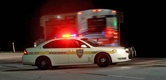 Police block the road to the Jacksonville International Airport terminal as a shuttle used to move people out of the airport drives by Tuesday, Oct. 1, 2013, in Jacksonville, Fla. The airport was evacuated after authorities found two suspicious packages.