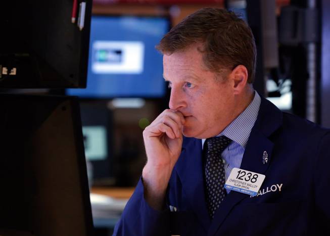 In this Wednesday, Oct. 2, 2013, file photo, trader Christopher Malloy works on the floor of the New York Stock Exchange. Financial markets remained fixated Thursday on developments in Washington as the partial shutdown of the U.S. government entered its third day and showed few signs of being resolved soon.