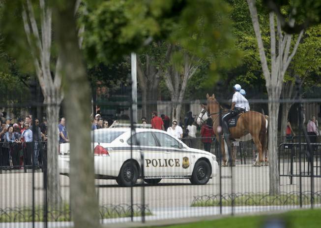 A Secret Service vehicle joins law enforcement officers on horseback from the US Park Police, as they shutdown access n Pennsylvania Ave., directly in front of the White House in Washington, Thursday, Oct. 3, 2013, after a shooting on Capitol Hill. Police say the U.S. Capitol has been put on a security lockdown amid reports of possible shots fired outside the building.