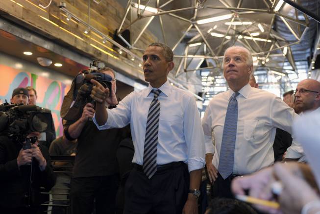 President Barack Obama and Vice President Joe Biden look up at the menu board as they order lunch at Taylor Gourmet sandwich shop near the White House in Washington, Friday, Oct. 4, 2013. The president and vice president stepped out of the White House on a surprise and rare off-campus stroll to grab lunch at a neighborhood eatery.
