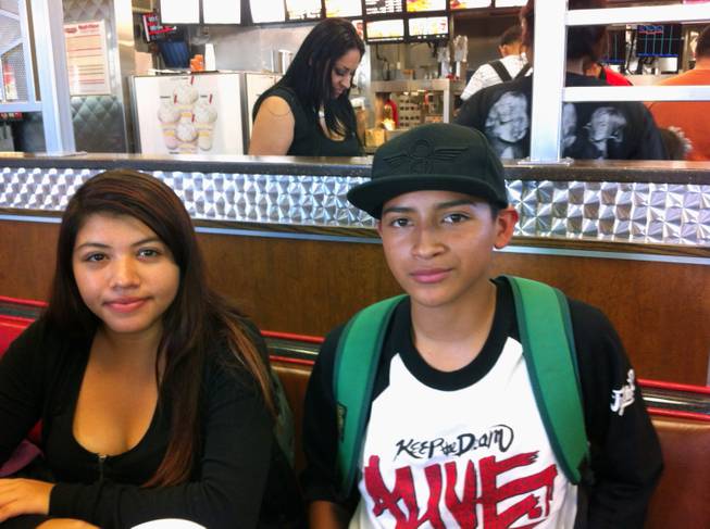This Oct. 1, 2013, photo shows Roosevelt High School students Carlos Espinoza and Maria Aguilera during an interview in Los Angeles. They were among two of the Los Angeles Unified School District's 650,000 students to receive iPads under a district plan to supply every student and teacher with one of the tablets by next year. Espinoza says he quickly cracked the iPad's security settings and used it to go on Facebook. Aguilera says district officials shouldn't have been surprised that hundreds of high school students would do that.