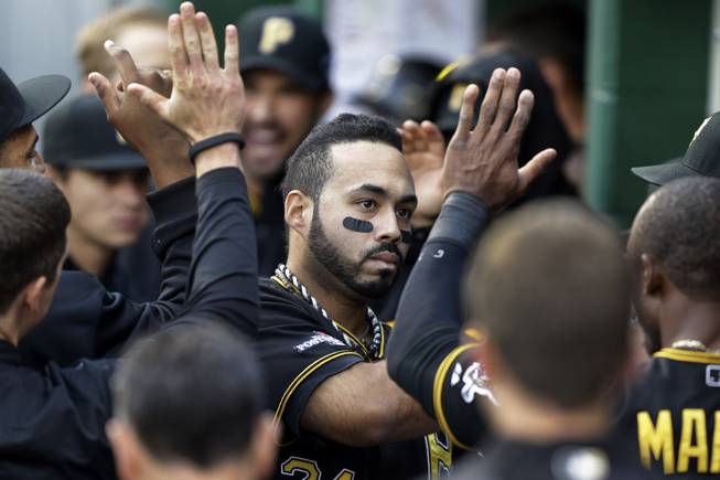 Pittsburgh Pirates' Pedro Alvarez celebrates with teammates in the dugout after getting the Pirates only hit of the game, a solo-home run off St. Louis Cardinals pitcher Michael Wacha in the eighth inning of Game 4 of a National League division baseball series on Monday, Oct. 7, 2013 in Pittsburgh. The Cardinals won 2-1, to even the best of five series a two games a piece.
