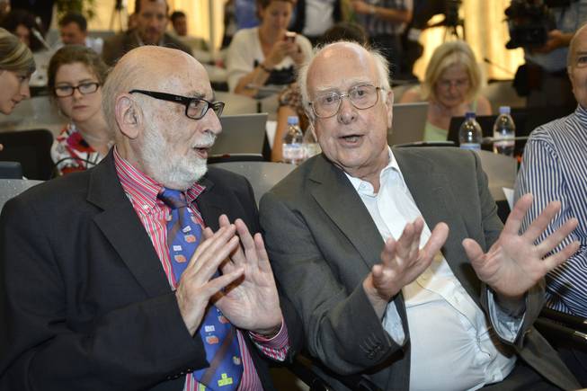 In this Wednesday, July 4, 2012, file photo, Belgian physicist Francois Englert, left, and British physicist Peter Higgs answer a journalist's question about the Higgs boson at the European Organization for Nuclear Research (CERN) in Meyrin, near Geneva. Englert and Higgs were awarded the Nobel physics prize on Tuesday, Oct. 8, 2013.