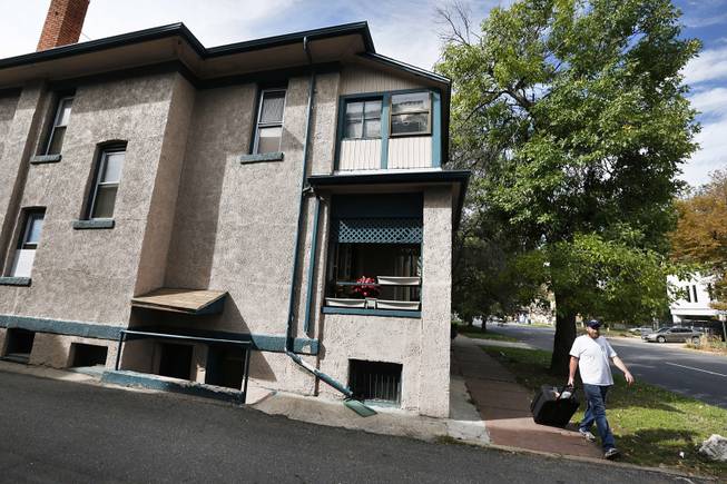 A man walks past the residence of Wayne Sperling, on Tuesday, Oct. 8 2013, the day of the first hearing in his felony child abuse case, in Denver. Sperling, 66, who is in custody, and Lorinda Bailey, 35, who is free on bond, are charged with child abuse for allegedly starving their four sons.