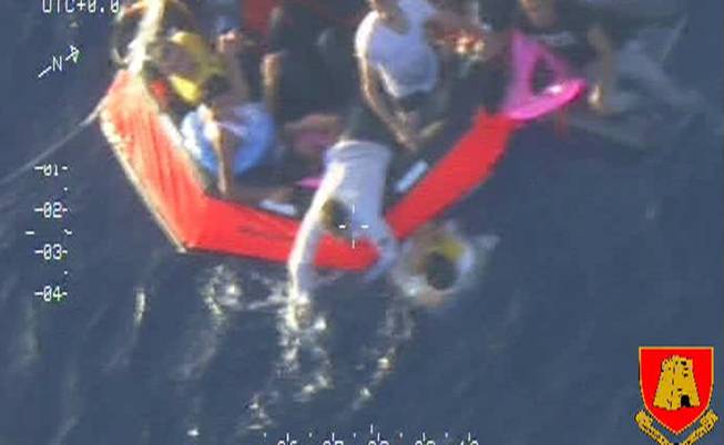In this video image made available by the Armed Forces of Malta from an overflying aircraft, a life raft carrying survivors floats in the sea between Malta and the Italian island of Lampedusa, Friday Oct. 11 2013, following the capsize of a boat carrying an estimated 200 migrants.