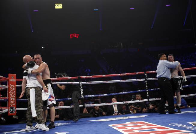Irish-American boxer Sean Monaghan (L) of New York celebrates with a member of his corner after defeating Anthony Smith of Pennsylvania in a light heavyweight bout at the Thomas & Mack Center in Las Vegas, Nevada, October 12, 2013. Monaghan won the fight with a third round TKO. REUTERS/Richard Brian (UNITED STATES)