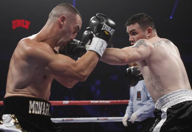 Irish-American boxer Sean Monaghan (L) of New York takes a punch from Anthony Smith of Pennsylvania during their light heavyweight bout at the Thomas & Mack Center in Las Vegas, Nevada, October 12, 2013. Monaghan won the fight with a third round TKO. REUTERS/Richard Brian (UNITED STATES)