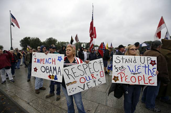 People rally at the World War II Memorial in Washington Sunday, Oct. 13, 2013. The rally was organized to protest the closure of the Memorial and access to it by World War II veterans who traveled there on Honor Flight visits. The memorial has been closed due to the partial federal government shutdown.