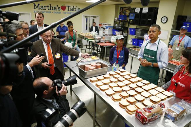 President Barack Obama speaks to reporters as he visits Martha's Table, which prepares meals for the poor and where furloughed federal employees are volunteering, in Washington, Monday, Oct. 14, 2013. President Obama spoke about the government shutdown and the looming debt ceiling during remarks to reporters during his visit.