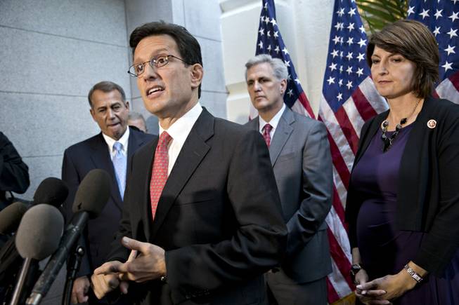 House Majority Leader Eric Cantor, R-Va., with House GOP leaders, speaks with reporters following a Republican strategy session, at the Capitol in Washington, Tuesday, Oct. 15, 2013. From left are Speaker of the House John Boehner, R-Ohio, House Majority Leader Eric Cantor, R-Va., House Majority Whip Kevin McCarthy, R-Calif., Rep. Cathy McMorris Rodgers, R-Wash., the Republican Conference chair. House GOP leaders Tuesday floated a plan to fellow Republicans to counter an emerging Senate deal to reopen the government and forestall an economy-rattling default on U.S. obligations. But the plan got mixed reviews from the rank and file and it was not clear whether it could pass the chamber.