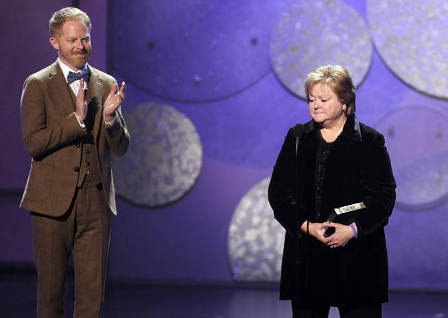 Judy Shepard, right, mother of the late Matthew Shepard and co-founder of the Matthew Shepard Foundation, is applauded by presenter Jesse Tyler Ferguson after she received an award at the first annual American Giving Awards, Friday, Dec. 9, 2011, in Los Angeles. The awards show granted two million dollars to five finalist charities.