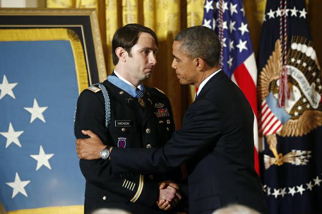 President Barack Obama shakes hands with former Army Captain William D. Swenson of Seattle, Wash., after he awarded him the Medal of Honor during a ceremony in the East Room at the White House in Washington, Tuesday, Oct. 15, 2013. Swenson was awarded the Medal of Honor Tuesday for his actions in a lengthy battle against Taliban insurgents in the Ganjgal valley near the Pakistan border on Sept. 8, 2009, which claimed the lives of five Americans, 10 Afghan army troops and an interpreter.