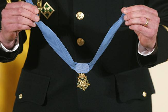 A military honor guard holds the Medal of Honor before President Barack Obama awards it to former Army Capt. William D. Swenson of Seattle, Wash., during a ceremony in the East Room at the White House in Washington, Tuesday, Oct. 15, 2013. Swenson was awarded the Medal of Honor Tuesday for his actions in a lengthy battle against the Taliban in the Ganjgal valley near the Pakistan border on Sept. 8, 2009, which claimed the lives of five Americans, 10 Afghan army troops and an interpreter.