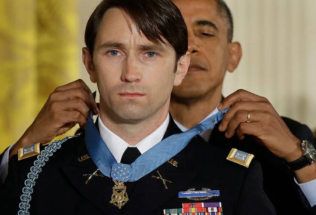 President Barack Obama awards the Medal of Honor to former Army Capt. William D. Swenson of Seattle, Wash., during a ceremony in the East Room at the White House in Washington, Tuesday, Oct. 15, 2013. Swenson was being awarded the Medal of Honor for his actions in a lengthy battle against Taliban insurgents in the Ganjgal valley near the Pakistan border on Sept. 8, 2009, which claimed the lives of five Americans, 10 Afghan army troops and an interpreter.