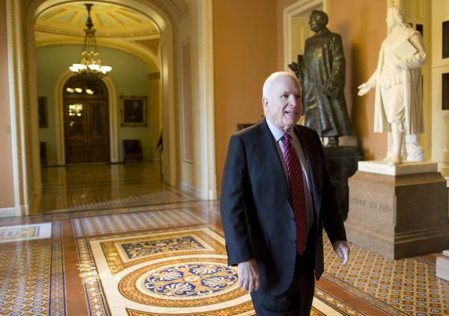 Sen. John McCain, R-Ariz., walks to a meeting with Senate Minority Leader Sen. Mitch McConnell, R-Ky., on Capitol Hill on Wednesday, Oct. 16, 2013 in Washington. The partial government shutdown is in its third week and less than two days before the Treasury Department says it will be unable to borrow and will rely on a cash cushion to pay the country's bills.