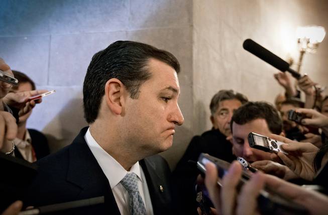 Sen. Ted Cruz, R-Texas, speaks to reporters waiting outside a closed-door meeting of Senate Republicans as news emerged that leaders reached a last-minute agreement to avert a threatened Treasury default and reopen the government after a partial, 16-day shutdown, at the Capitol in Washington, Wednesday, Oct. 16, 2013.