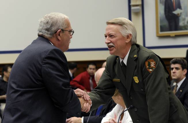 Rep. Gerry Connolly, D-Va., left, shakes hands with National Park Service Director Jonathan Jarvis, right, before the start of a joint hearing with the House Natural Resources Committee and the House Oversight and Government Reform Committee on Capitol Hill in Washington, Wednesday, Oct. 16, 2013.