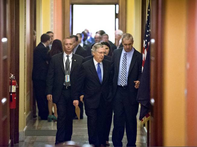 Senate Minority Leader Mitch McConnell, R-Ky., walks to the floor from a closed-door meeting with Republican senators at the Capitol in Washington, Wednesday, Oct. 16, 2013. McConnell and his Democratic counterpart, Senate Majority Leader Harry Reid, D-Nev., reached last-minute agreement Wednesday to avert a threatened Treasury default and reopen the government after a partial, 16-day shutdown.