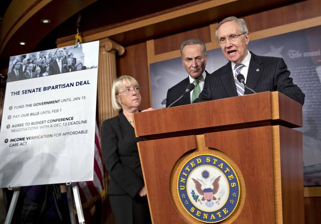 Senate Majority Leader Harry Reid, D-Nev., speaks with reporters after voting on a measure to avert a threatened Treasury default and reopen the government after a partial, 16-day shutdown, at the Capitol in Washington, Wednesday, Oct. 16, 2013, as Sen. Patty Murray, D-Wash., chair of the Senate Budget Committee, Sen. Chuck Schumer, D-N.Y., listen.