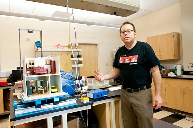 Lab manager Chris Cothrun explains how a visual shake table can help illustrates to Nevadans in the event of an earthquake prior to the Great Nevada ShakeOut earthquake drill held in the Applied Geophysics Center at UNLV at 10:17 a.m. Thursday morning in Las Vegas, October 17, 2013.