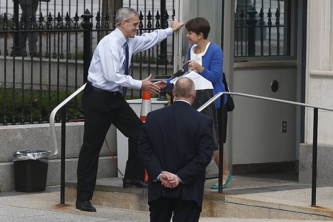 White House Chief of Staff Denis McDonough stands at the entrance to the Eisenhower Executive Office Building as he greets federal employees as they return to the White House in Washington, Thursday, Oct. 17, 2013. Lawmakers Wednesday voted to avoid a financial default and reopen the government after a 16-day partial shutdown.