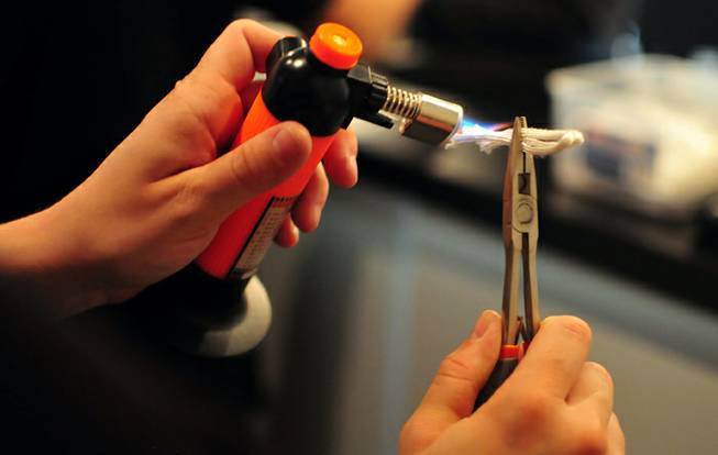A wick for nicotine and flavored juices is shown being heated on Friday, Oct. 11, 2013, at The Vapery, a local vapor shop located at 8060 S. Rainbow Road. The rise in e-cigarette use among young adults and teenagers is a growing concern among health officials, who have long waged a public health campaign against smoking.