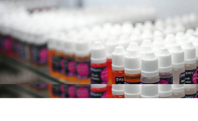 Dozens of vials of flavored liquid nicotine and non-nicotine "juices" are on display at The Vapery, a local vapor shop located at 8060 S. Rainbow Road, on Friday, Oct. 11, 2013. The rise in e-cigarette use among young adults and teenagers is a growing concern among health officials, who have long waged a public health campaign against smoking.