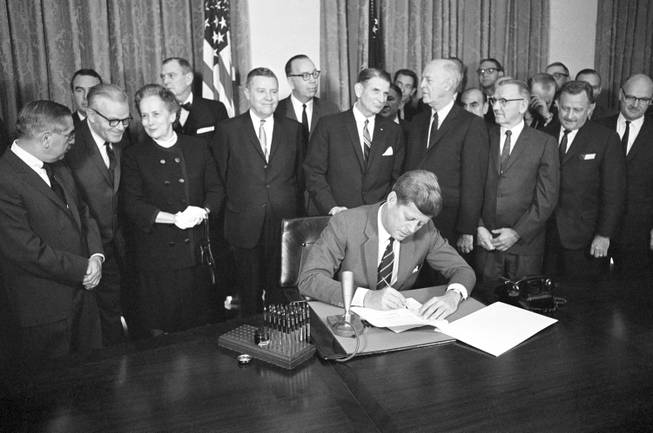 In this Oct. 31, 1963, file photo, President John F. Kennedy signs a bill authorizing $329 million for mental health programs. The Community Mental Health Act, the last legislation that Kennedy signed, aimed to build 1,500 mental health centers so those with mental illnesses could be treated while living at home, rather than being kept in state institutions. It brought positive changes, but was never fully funded. Former U.S. Rep. Patrick Kennedy will host a conference on Oct. 24, 2013, in Boston, to mark the 50th anniversary of the act and formulate an agenda to continue improving mental health care.