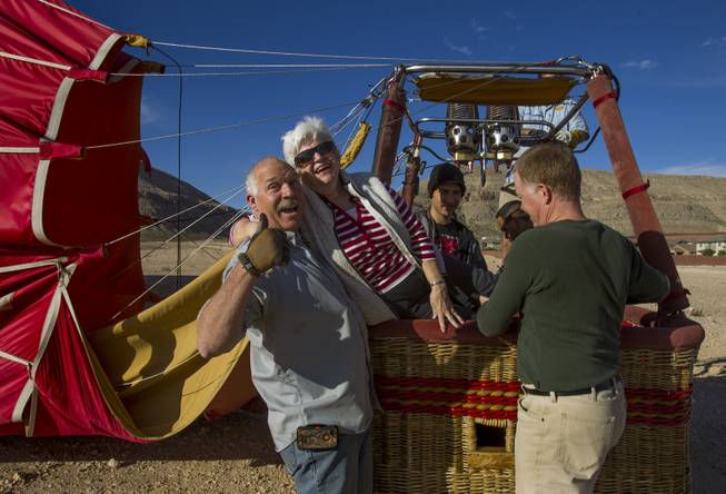 (From left) Viva Vegas crew member Larry Johnson assists Dona Miller of Moses Lake, Wash., out of the gondola Wednesday after a smooth landing west of the city. The Second Annual Hot Air Balloon Festival and Carnival takes place this weekend sponsored by Friends of LVMPD Search and Rescue and Southern Hills Hospital. October 18, 2013.