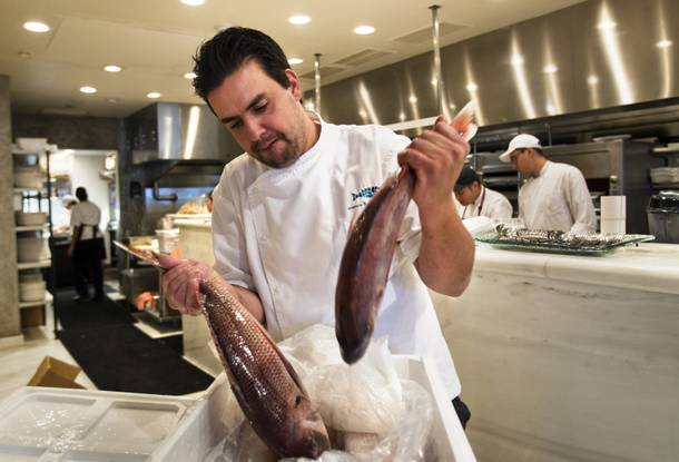 Milos chef Nikos Georgousis unwraps and sorts a fresh shipment of lithrini on Wednesday Oct. 23, 2013.