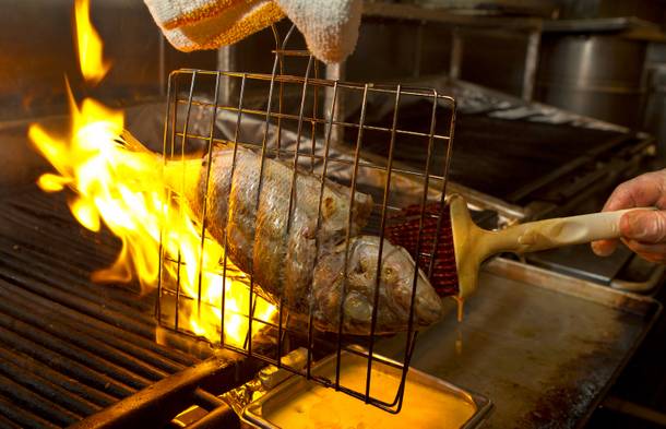 A lithrini is cooked over fire at Milos in the Cosmopolitain on Wednesday Oct. 23, 2013.