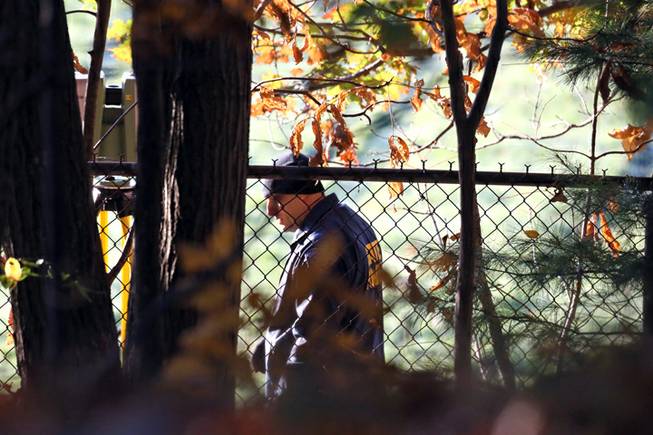 Massachusetts State Police detectives are seen at the Danvers High School, investigating a report of a sudden death inside the school, Wednesday, Oct. 23, 2013, in Danvers, Mass. A 14-year-old high school student is facing a murder charge in the death of a 24-year-old teacher found dead in the woods behind the school. Essex District Attorney Jonathan Blodgett on Wednesday identified the victim as Danvers High School teacher Colleen Ritzer, of Andover.