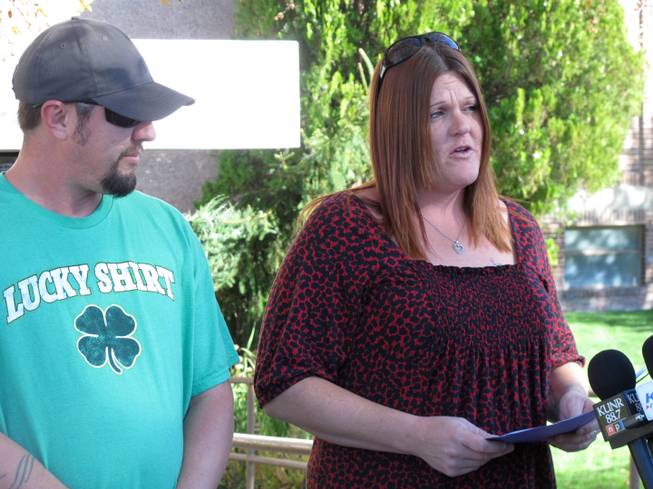 Jenifer Davis, whose son Mason was shot in the stomach by a gunman who killed a teacher and wounded another student before taking his own life, tells reporters outside a Reno, Nev., hospital on Wednesday, Oct. 23, 2013, she doesn't believe her 12-year-old boy was a target of the shooting spree. Davis, accompanied by an identified man, said Mason is recovering well after he was shot outside Sparks Middle School on Oct. 21 wihle trying to come to the aid of the mortally wounded teacher, Michael Landsberry.