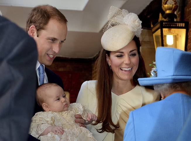 Britain's Queen Elizabeth II, right, speaks with Prince William and Kate Duchess of Cambridge as they arrive with their son Prince George at the Chapel Royal in St James's Palace, Wednesday Oct. 23, 2013. Britain's 3-month-old future monarch, Prince George will be christened Wednesday with water from the River Jordan at a rare four-generation gathering of the royal family in London.