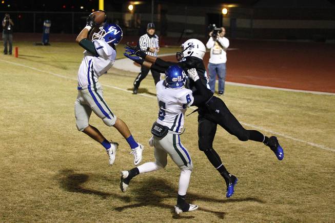 Green Valley safety Gio Hernandez intercepts the ball in the end zone, which was nullified when Green Valley cornerback Jacob Rivero was called for pass interference on Canyon Springs wide receiver Jordan Davis, during their game Thursday, Oct. 24, 2013. Green Valley won 44-43 on a last second field goal.