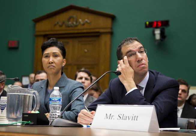 Cheryl Campbell, senior vice president of CGI listens at left as Andy Slavitt, representing QSSI's parent company, testifies on Capitol Hill in Washington, Thursday, Oct. 24, 2013, before the House Energy and Commerce Committee hearing with contractors that built the federal government's health care websites. The contractors responsible for building the troubled Healthcare.gov website say it was the government's responsibility — not theirs — to test it and make sure it worked.
