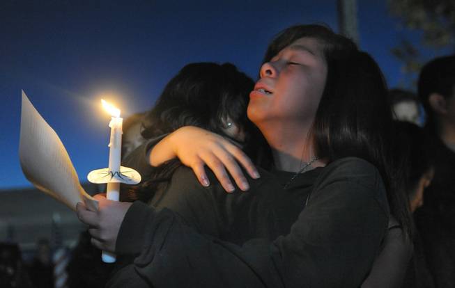 Jannelle Tan grieves for her teacher Michael Landsberry during a vigil held at Sparks Middle School on Wednesday, Oct. 23, 2013, in Sparks. Monday's shooting left Landsberry dead and two students injured. Several hundred people attended the interfaith memorial.