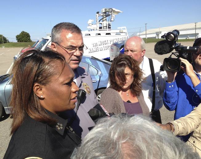 Police Chief Rita Stanback and Fire Chief Gary Graves, second from left, of Millington, Tenn., brief reporters about a shooting near a U.S. Naval Support Activity Mid-South on Thursday, Oct. 24, 2013, in Millington, Tenn. The Navy said two soldiers were wounded, though neither had life-threatening injuries.