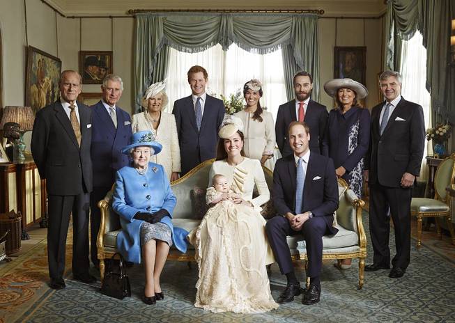 This image made available by Camera Press shows the official christening photo of Britain's Prince George photographed in the Morning Room at Clarence House in London on Wednesday Oct. 23, 2013. Kate Duchess of Cambridge holds her son Prince George seated next to Queen Elizabeth II and Prince William, back row from left, Prince Philip, Prince Charles, and the Duchess of Cornwall, Prince Harry, Pippa Middleton, James Middleton, Carole Middleton and Michael Middleton.