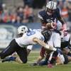 Photo: BYU's Jamaal Williams takes a hit from Boise State Photo: BYU's Jamaal Williams takes a hit from Boise State