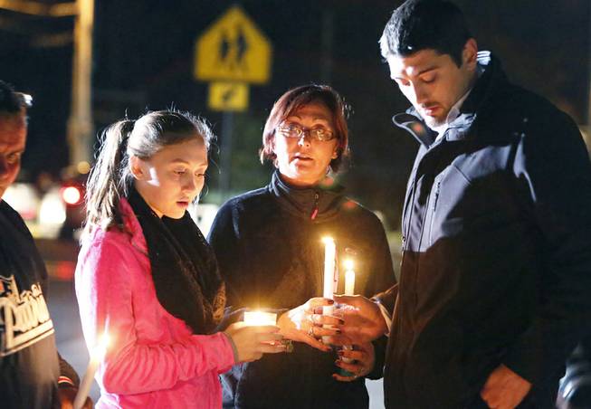 Parents and Danvers High School students hold candlelight vigil to mourn the death of Colleen Ritzer, a 24-year-old math teacher at Danvers High School, on Wednesday, Oct 23, 2013, in Danvers, Mass. Ritzer's body was found in woods behind the high school, and Danvers High School student Philip Chism, 14, who was found walking along a state highway overnight was charged with killing her.