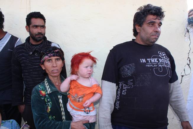 Mother Sasha Ruseva holds two-year-old Penka, one of her ten children, whom she claims is albino with father Atanas, right, as they talk to journalists in the town of Nikolaevo , Bulgaria, Thursday Oct. 24, 2013. DNA tests have confirmed that a Bulgarian Roma couple living in the impoverished village with their nine other children are the biological parents of the girl found in Greece with another Roma couple, authorities said Friday.