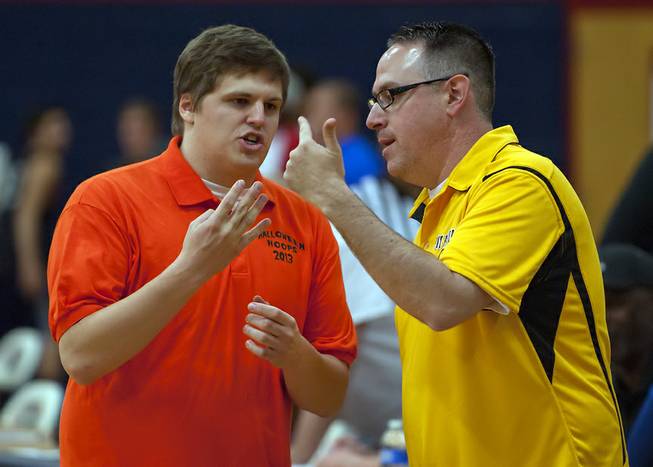Halloween Hoops All-Stars celebrity coaches Case Keefer, left, and Ray Brewer discuss strategies during warmups before their squad takes to the court against Findlay Prep at Coronado High School on Saturday night. Keefer and Brewer are part of the Las Vegas Sun sports staff.