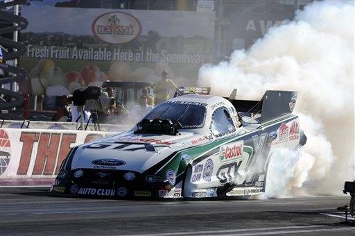 In this photo provided by NHRA, veteran Funny Car driver John Force powered his Castrol GTX Ford Mustang to his third consecutive event victory and clinched the 2013 NHRA Mello Yello world championship title Sunday, Oct. 28, 2013, at the NHRA Toyota Nationals at The Strip at Las Vegas Motor Speedway. Force defeated his youngest daughter Courtney with a 4.062 second run at 310.63 mph in the final round.