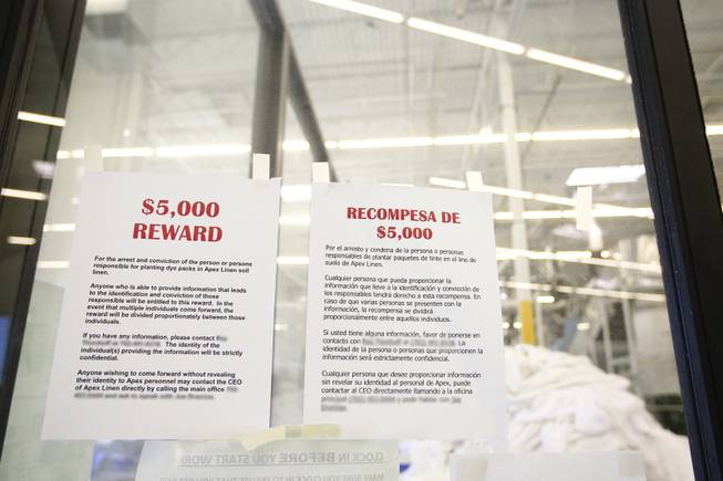 Hoping to discover the anonymous perpetrator who is sewing in ink packets into linens, $5,000 reward posters are posted in the work areas at Apex Linen in Las Vegas Tuesday, October 30, 2013. (Contact names and telephone numbers have been blurred for confidentiality purposes.)